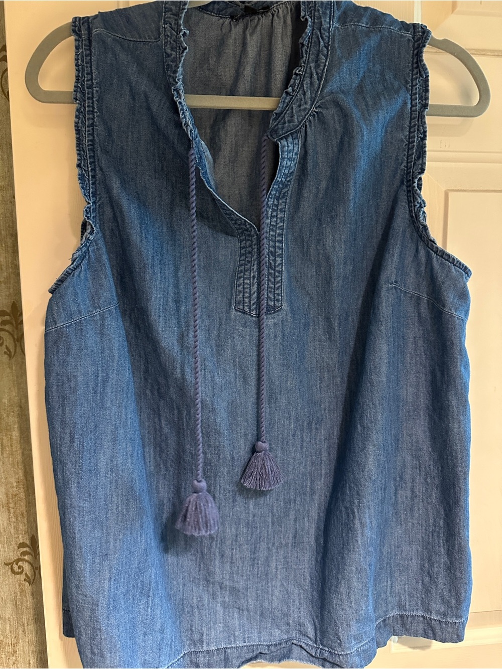 This season, Talbots sleeveless denim top with ruffle on arm and tassles